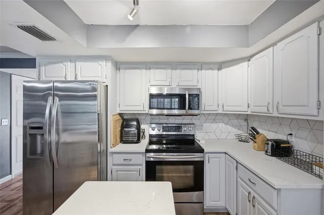 a kitchen with stainless steel appliances a refrigerator stove and sink