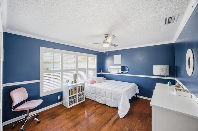 a bedroom with a bed and a chair