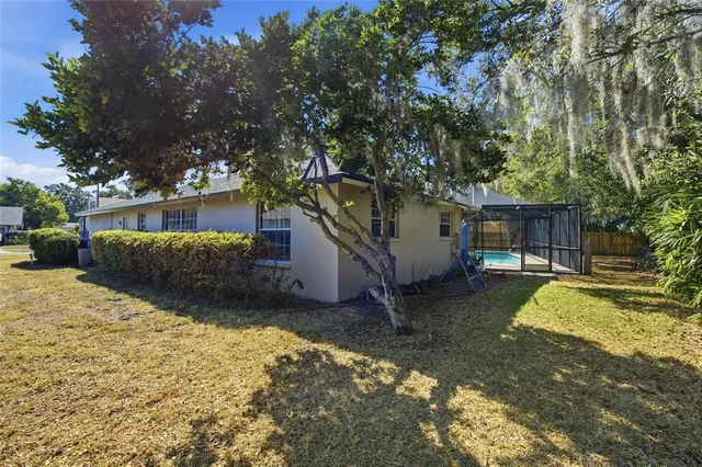 a view of a house with a yard covered in snow