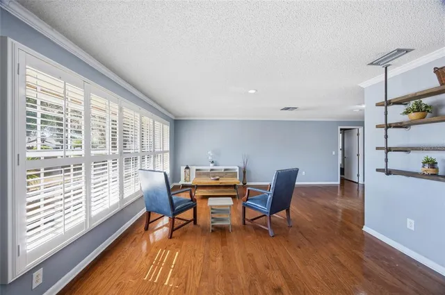 a dining room with furniture and wooden floor