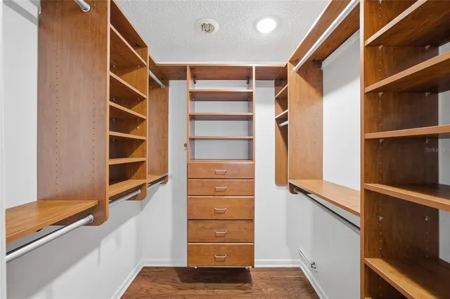 a view of walk in closet with empty racks