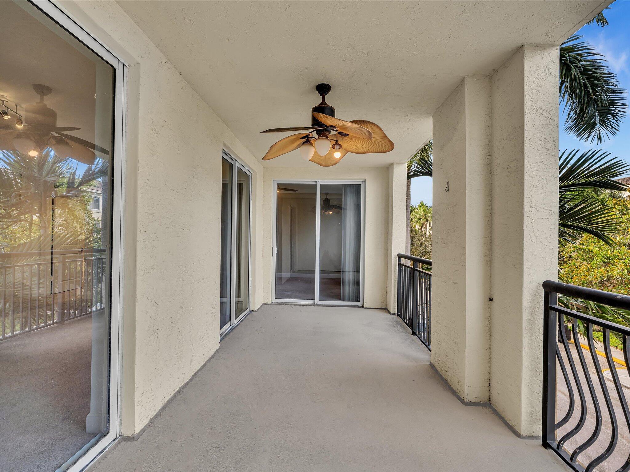 4303 Renaissance Way, Unit 303 Boynton Beach, FL 33426 - Photo 28 of 74 a view of a hallway with windows and chandelier