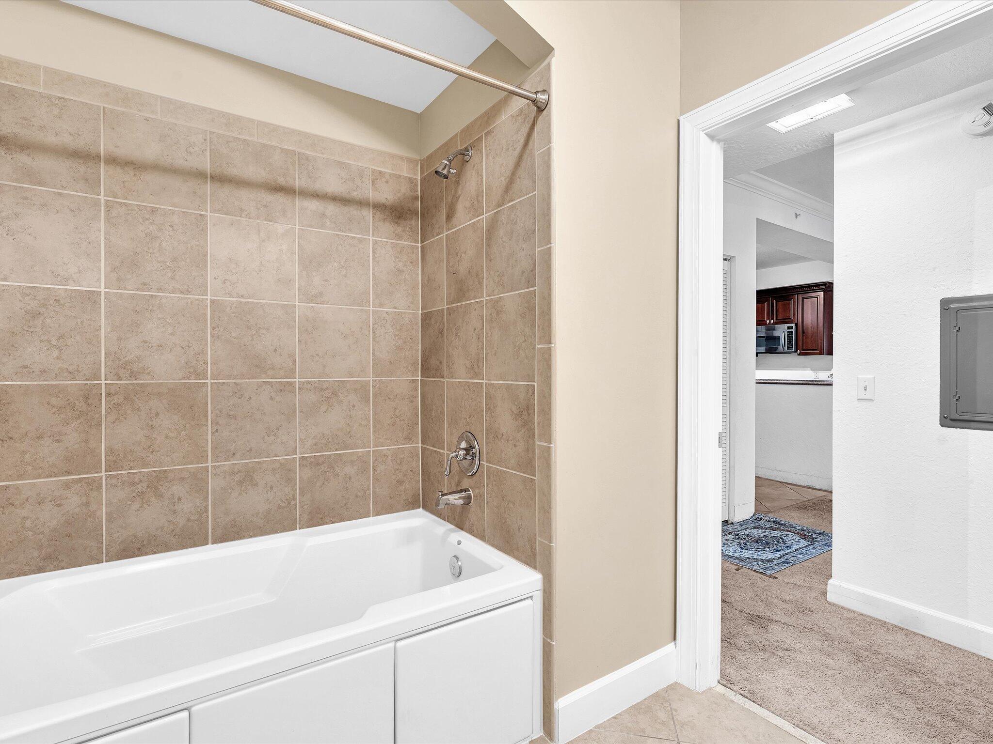 4303 Renaissance Way, Unit 303 Boynton Beach, FL 33426 - Photo 38 of 74 a bathroom with a bathtub and a shower