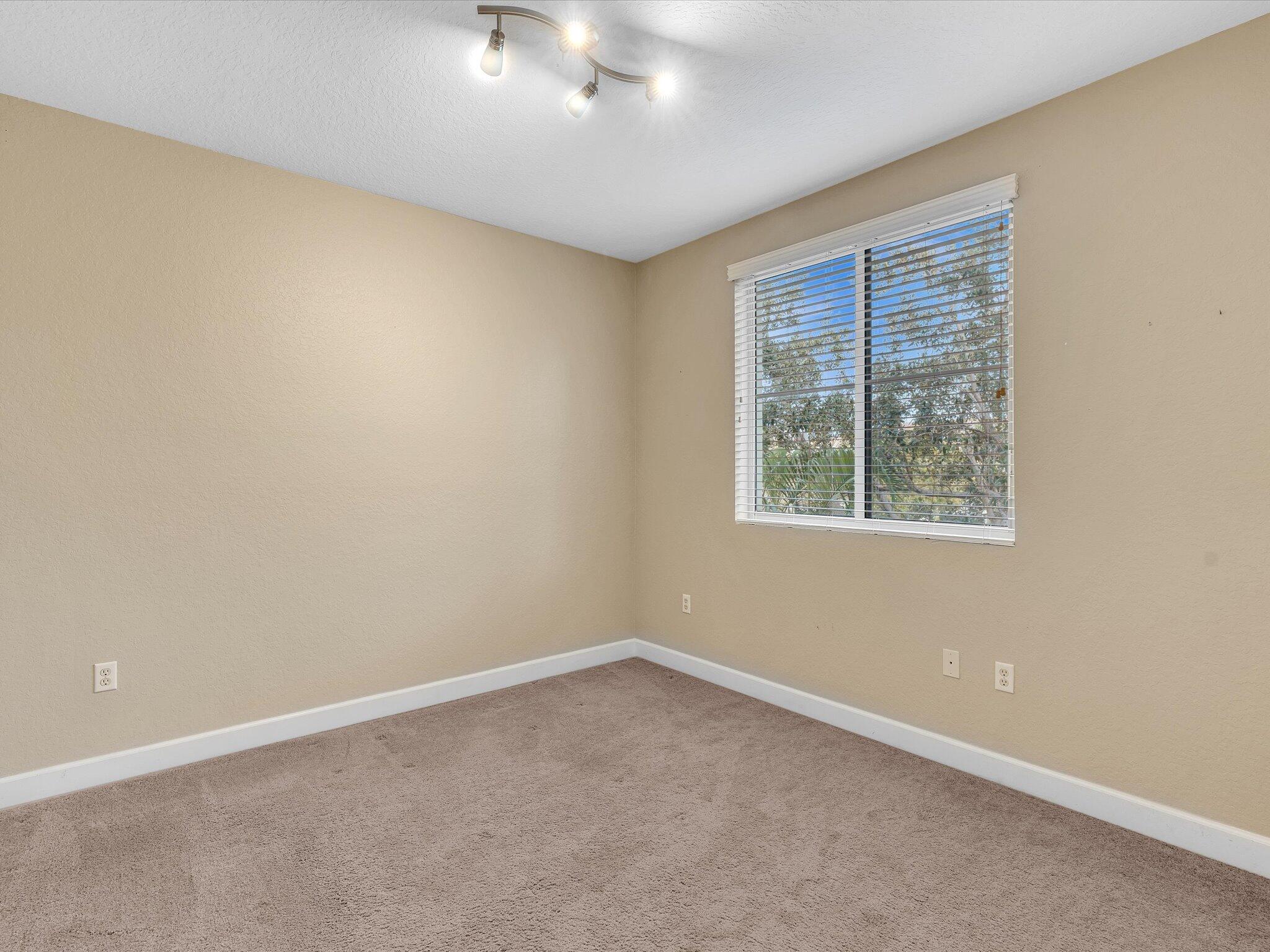 4303 Renaissance Way, Unit 303 Boynton Beach, FL 33426 - Photo 39 of 74 an empty room with windows