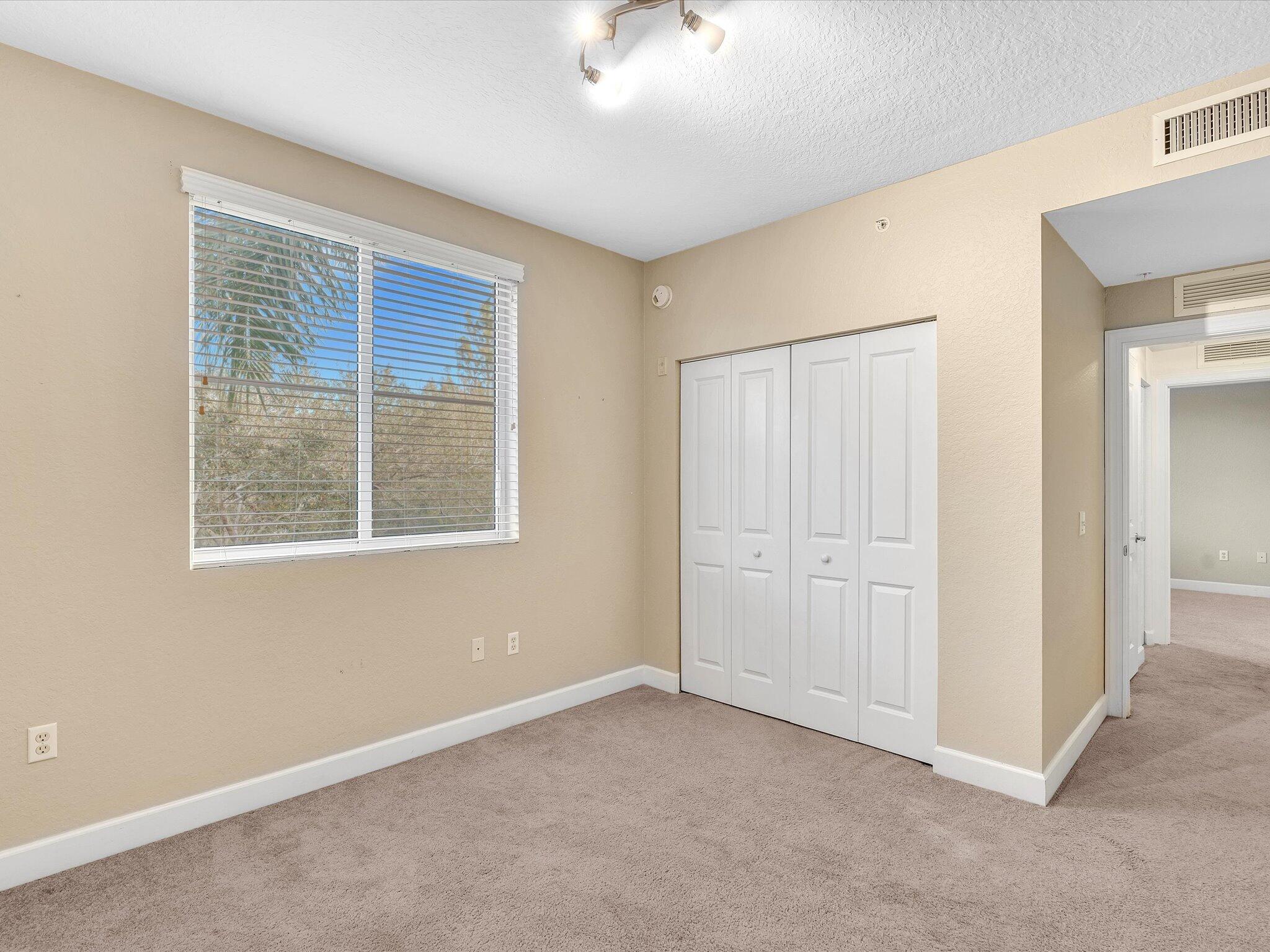 4303 Renaissance Way, Unit 303 Boynton Beach, FL 33426 - Photo 40 of 74 an empty room with windows