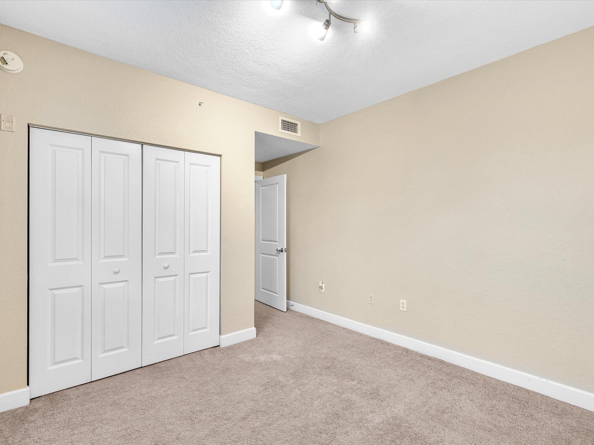 4303 Renaissance Way, Unit 303 Boynton Beach, FL 33426 - Photo 41 of 74 an empty room with a empty space and a ceiling fan