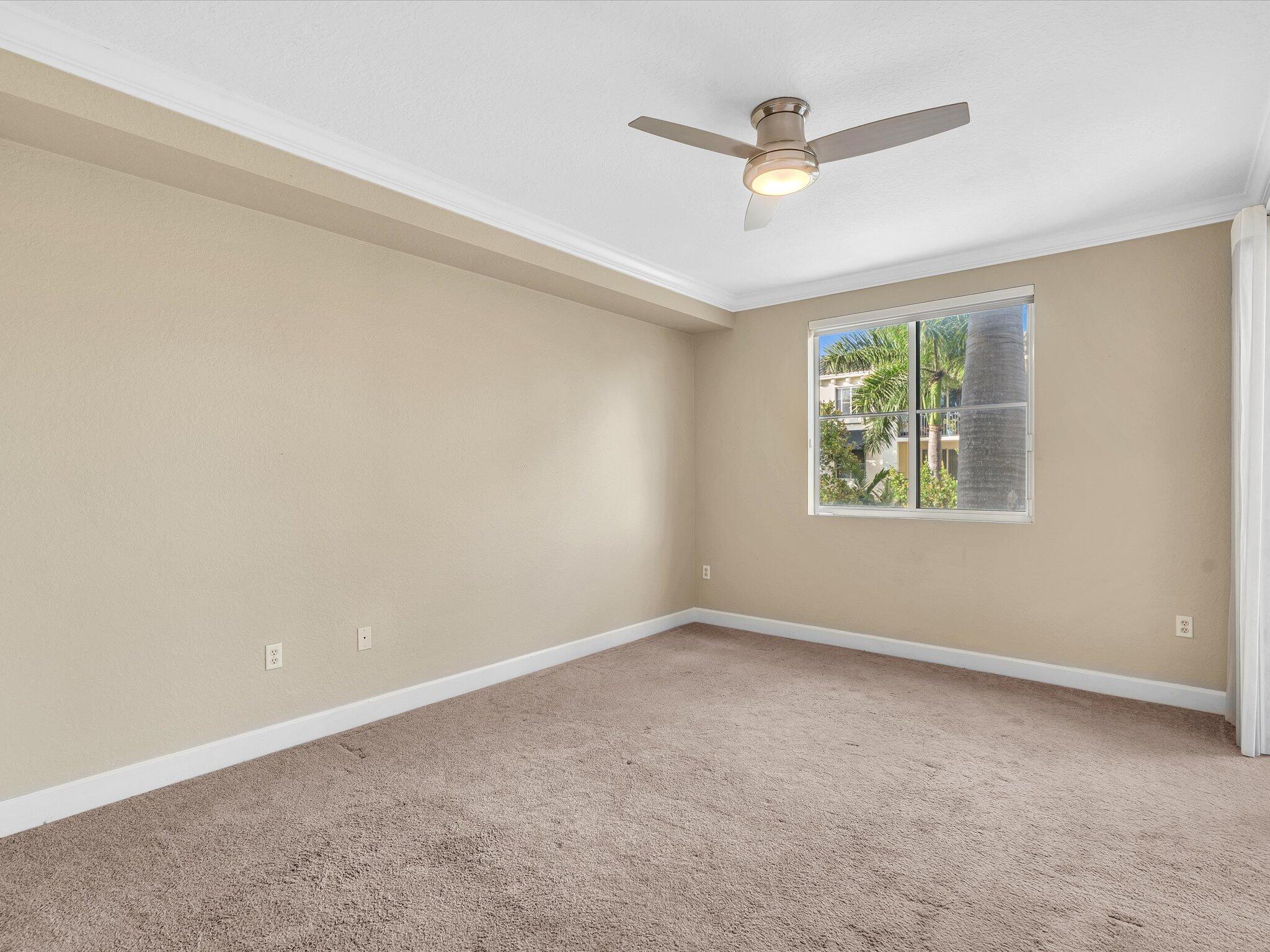 4303 Renaissance Way, Unit 303 Boynton Beach, FL 33426 - Photo 42 of 74 an empty room with windows and ceiling fan