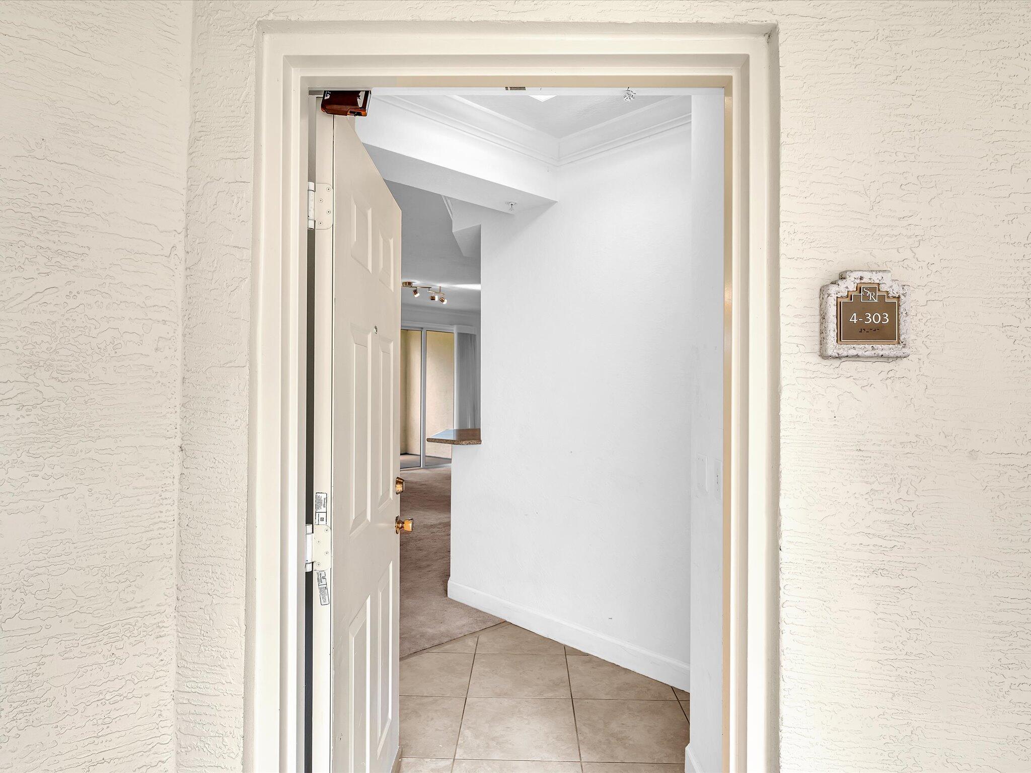 4303 Renaissance Way, Unit 303 Boynton Beach, FL 33426 - Photo 9 of 74 a view of a bathroom from a hallway