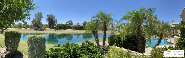 a view of a lake with a house in the background