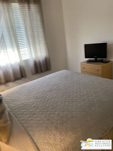 a view of a hallway to rooms