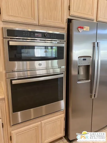 a kitchen with granite countertop cabinets and steel stainless steel appliances