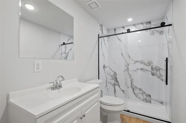 a bathroom with a sink toilet and shower