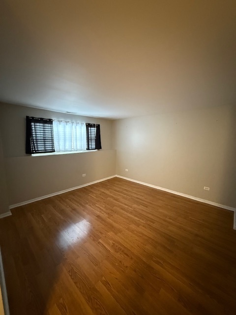 34404 North Barberry Road Round Lake, IL 60073 - Photo 12 of 14 a view of an empty room with wooden floor and a window