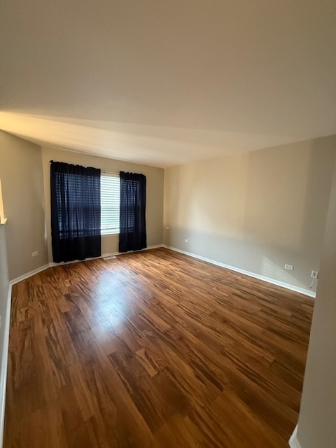 34404 North Barberry Road Round Lake, IL 60073 - Photo 4 of 14 a view of an empty room with a window and wooden floor