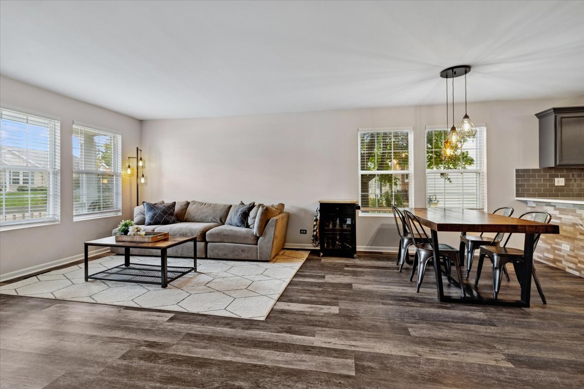 60 Wingate Drive, Unit 60 Oswego, IL 60543 - Photo 18 of 23 a living room with furniture a window and a dining table