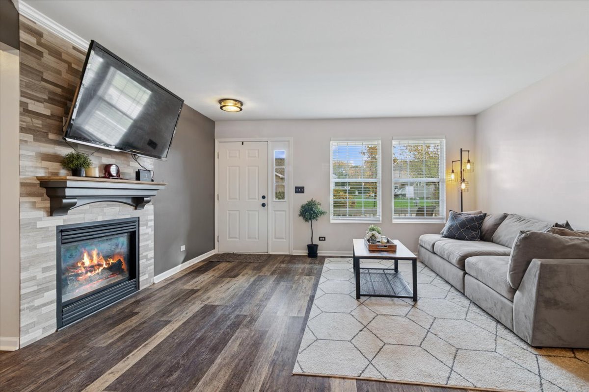 60 Wingate Drive, Unit 60 Oswego, IL 60543 - Photo 2 of 23 a living room with furniture and a fireplace