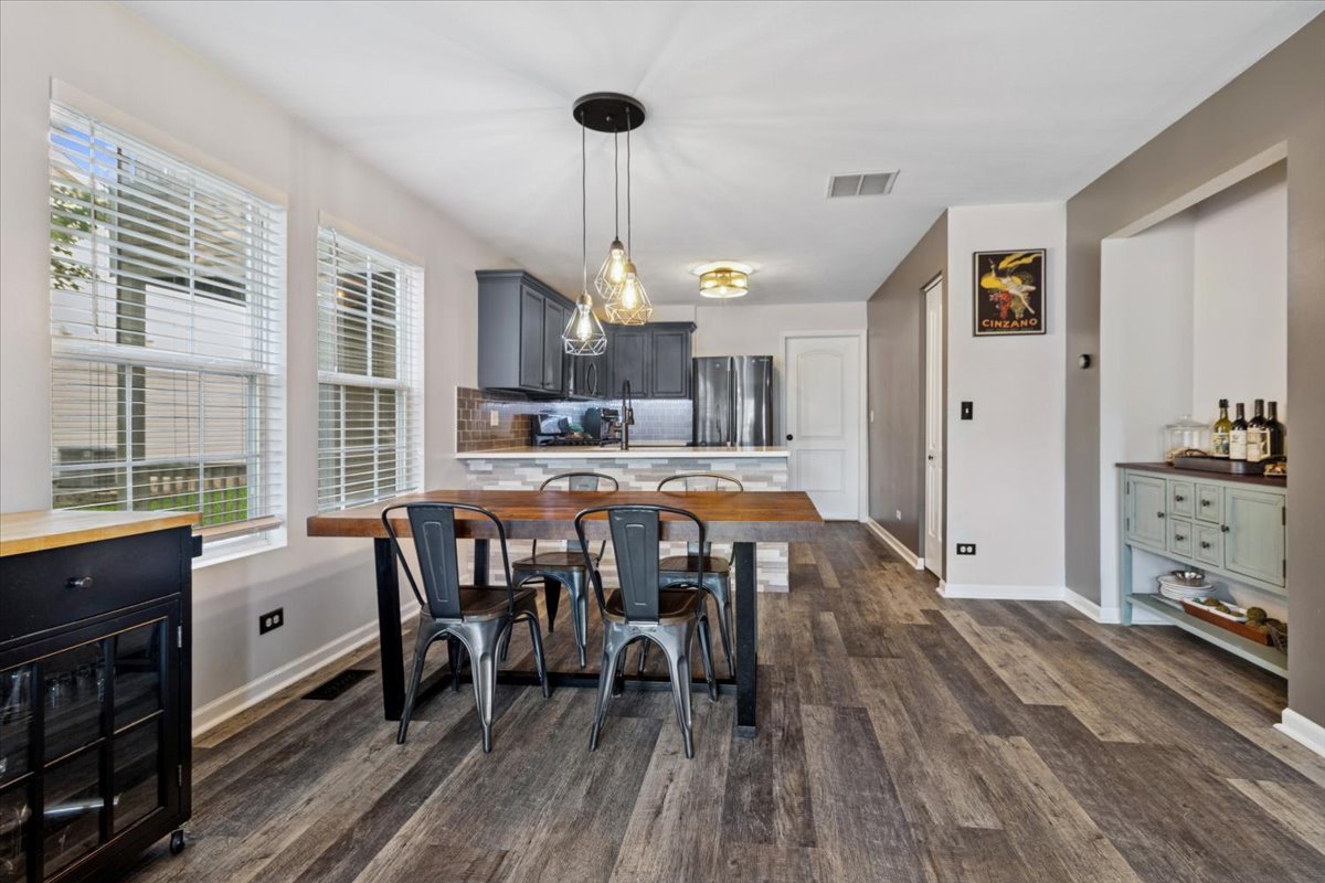 60 Wingate Drive, Unit 60 Oswego, IL 60543 - Photo 5 of 23 a dining room with furniture a chandelier and wooden floor