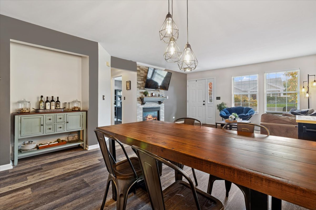 60 Wingate Drive, Unit 60 Oswego, IL 60543 - Photo 6 of 23 a dining room with furniture a chandelier and wooden floor