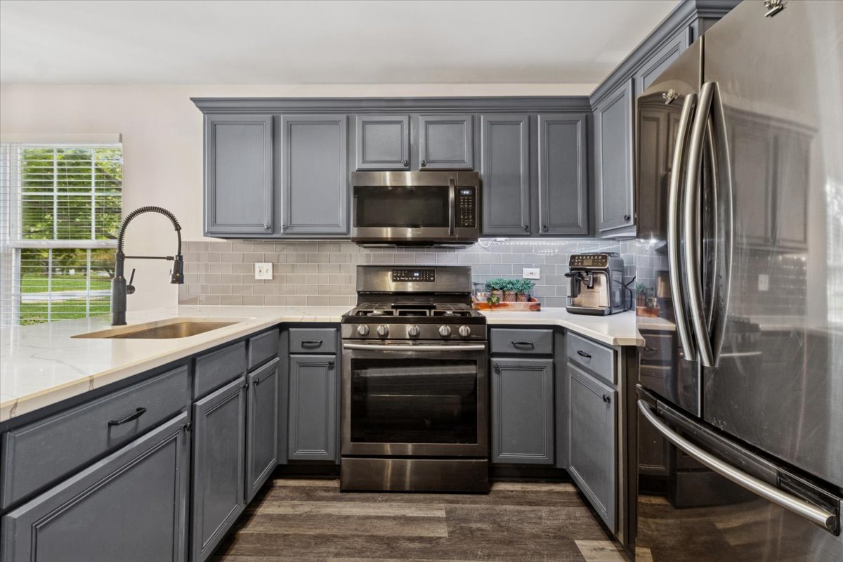 60 Wingate Drive, Unit 60 Oswego, IL 60543 - Photo 8 of 23 a kitchen with a refrigerator stove and sink