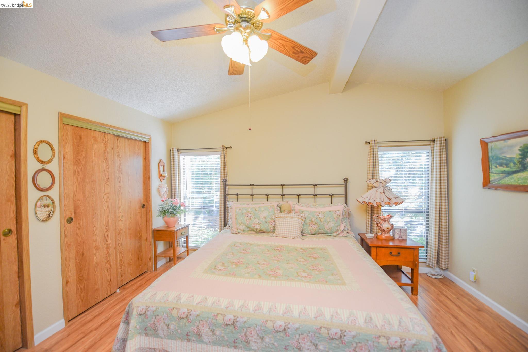 18717 Mill Villa Road, Unit 235 Jamestown, CA 95327 - Photo 16 of 24 Bedroom featuring light wood-type flooring, ceiling fan, and multiple closets