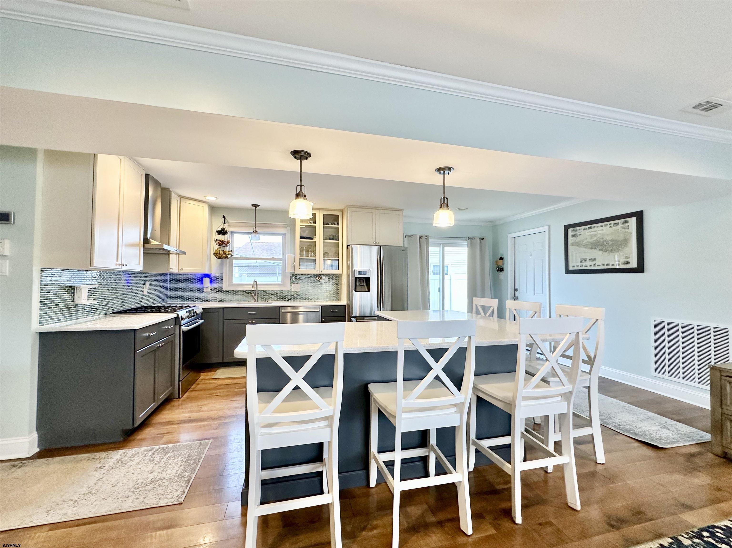 12 Explorer Road Brigantine, NJ 08203 - Photo 12 of 44 a large kitchen with a table and chairs