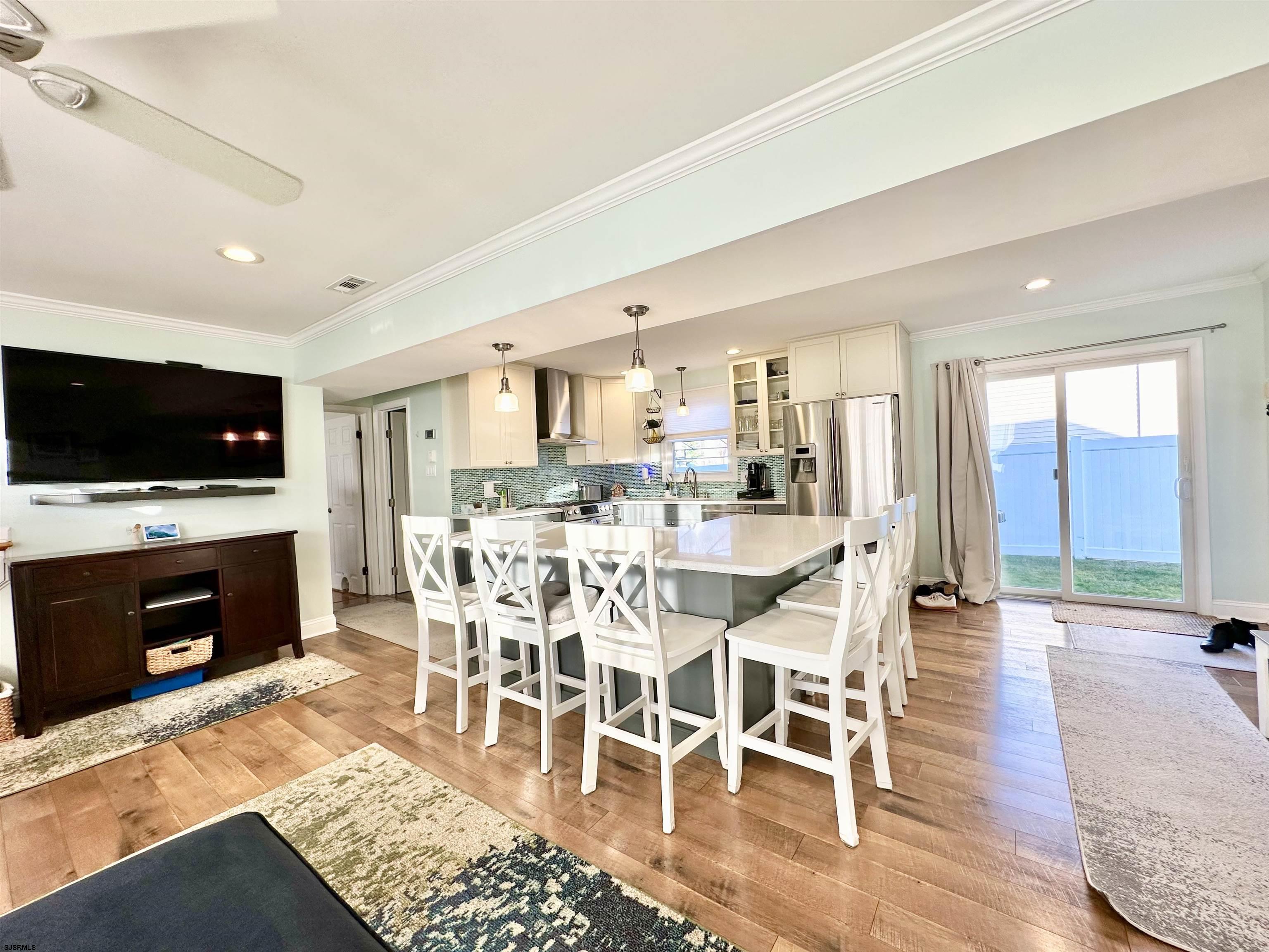 12 Explorer Road Brigantine, NJ 08203 - Photo 14 of 44 a view of a dining room with furniture wooden floor and chandelier