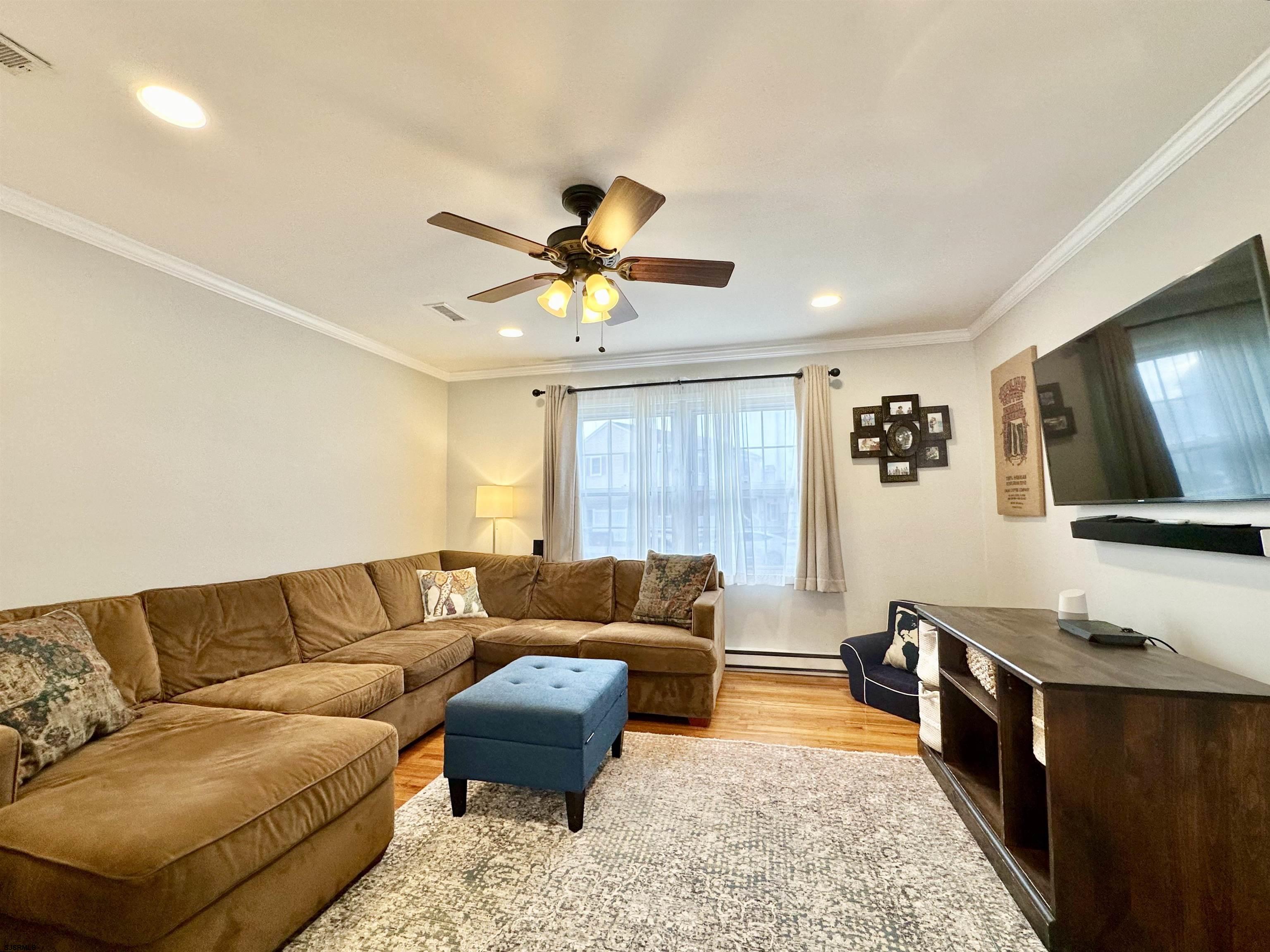 12 Explorer Road Brigantine, NJ 08203 - Photo 16 of 44 a living room with furniture and a flat screen tv