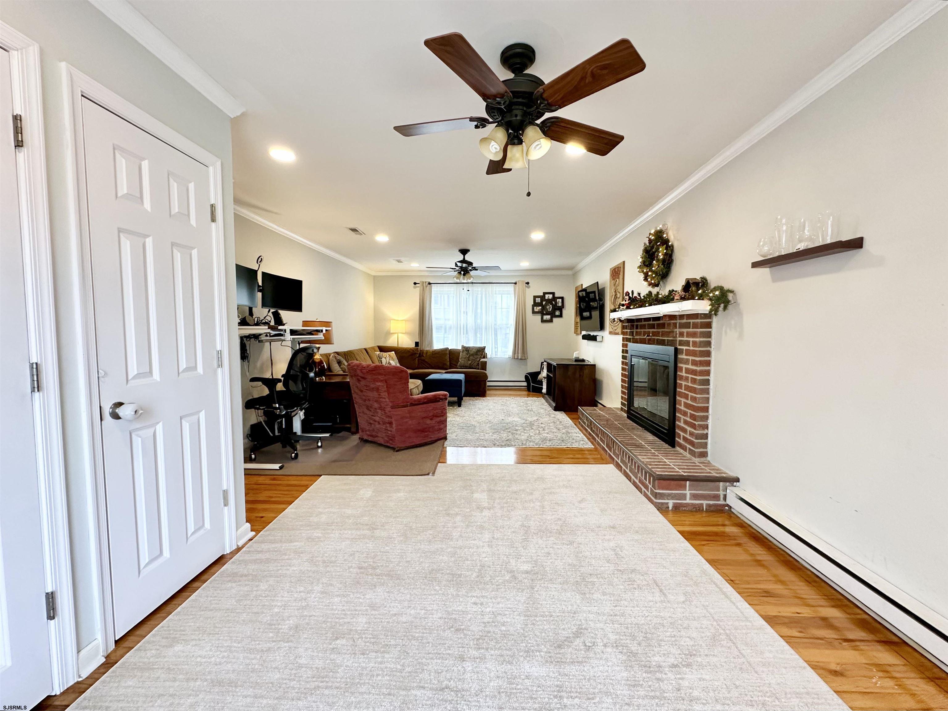 12 Explorer Road Brigantine, NJ 08203 - Photo 17 of 44 a living room with furniture and a fireplace