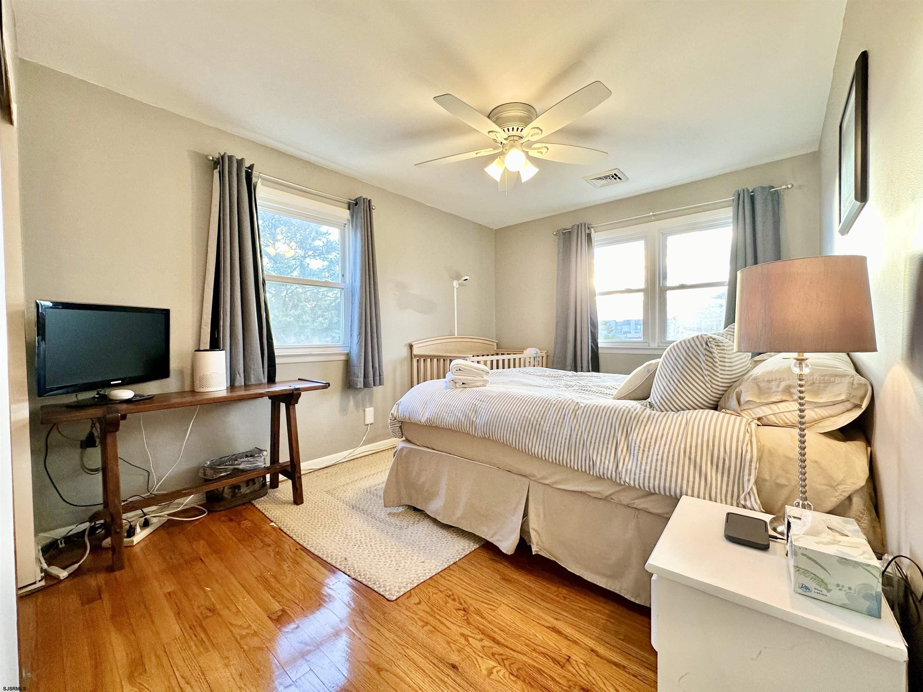 12 Explorer Road Brigantine, NJ 08203 - Photo 24 of 44 a bedroom with a bed and large window