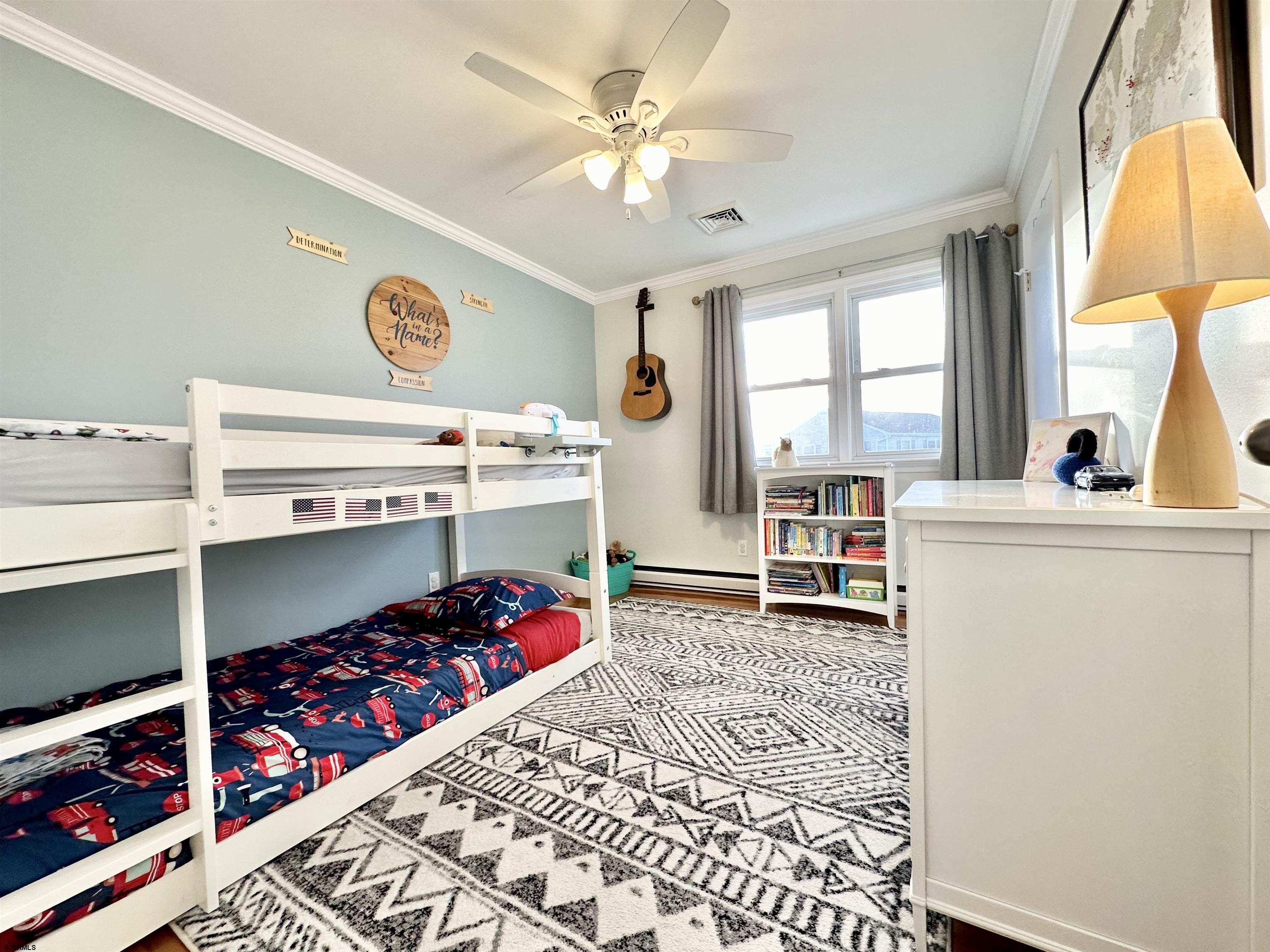 12 Explorer Road Brigantine, NJ 08203 - Photo 25 of 44 a bedroom with a bed and a chandelier