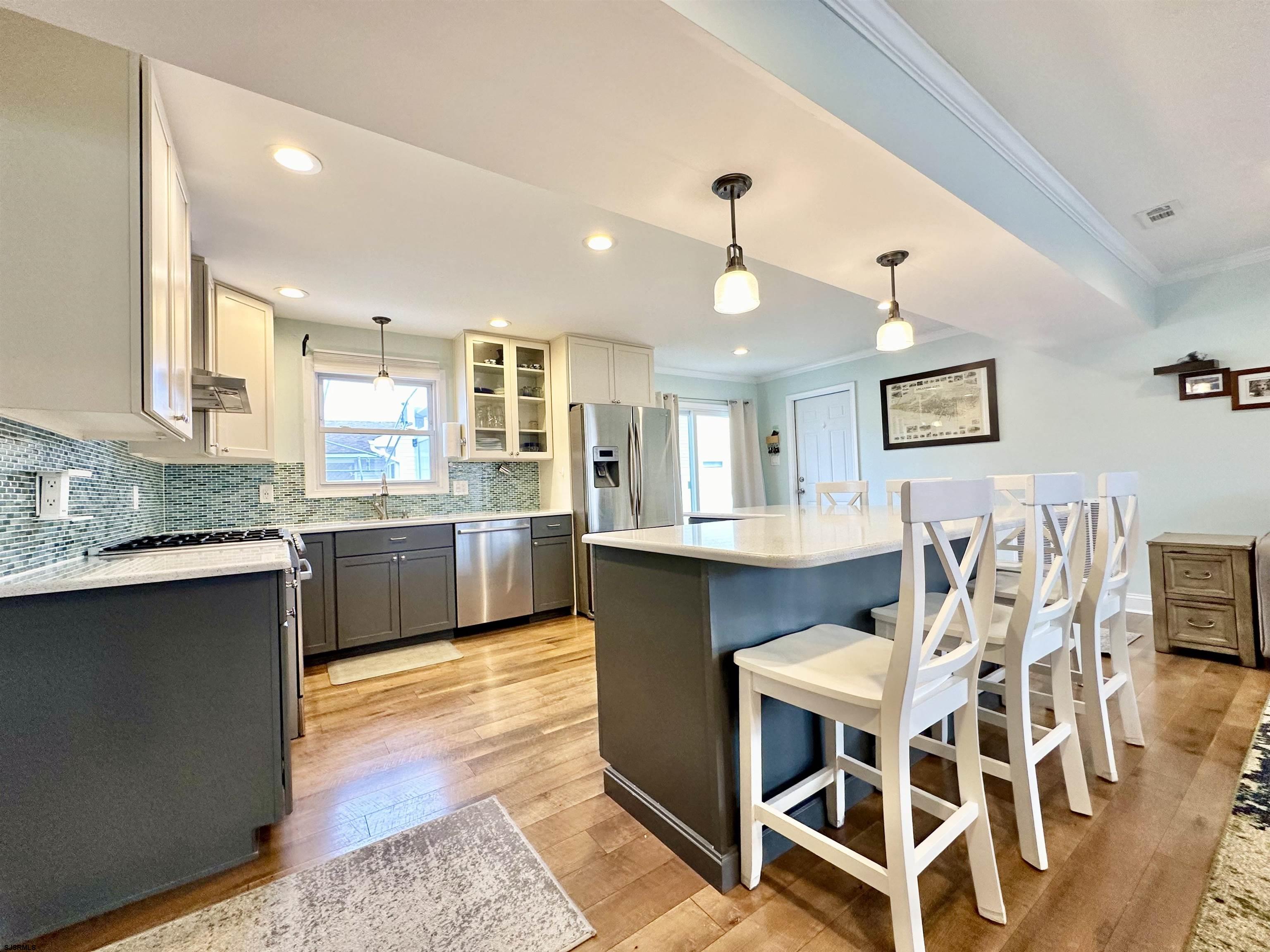 12 Explorer Road Brigantine, NJ 08203 - Photo 7 of 44 a large kitchen with a table and chairs in it
