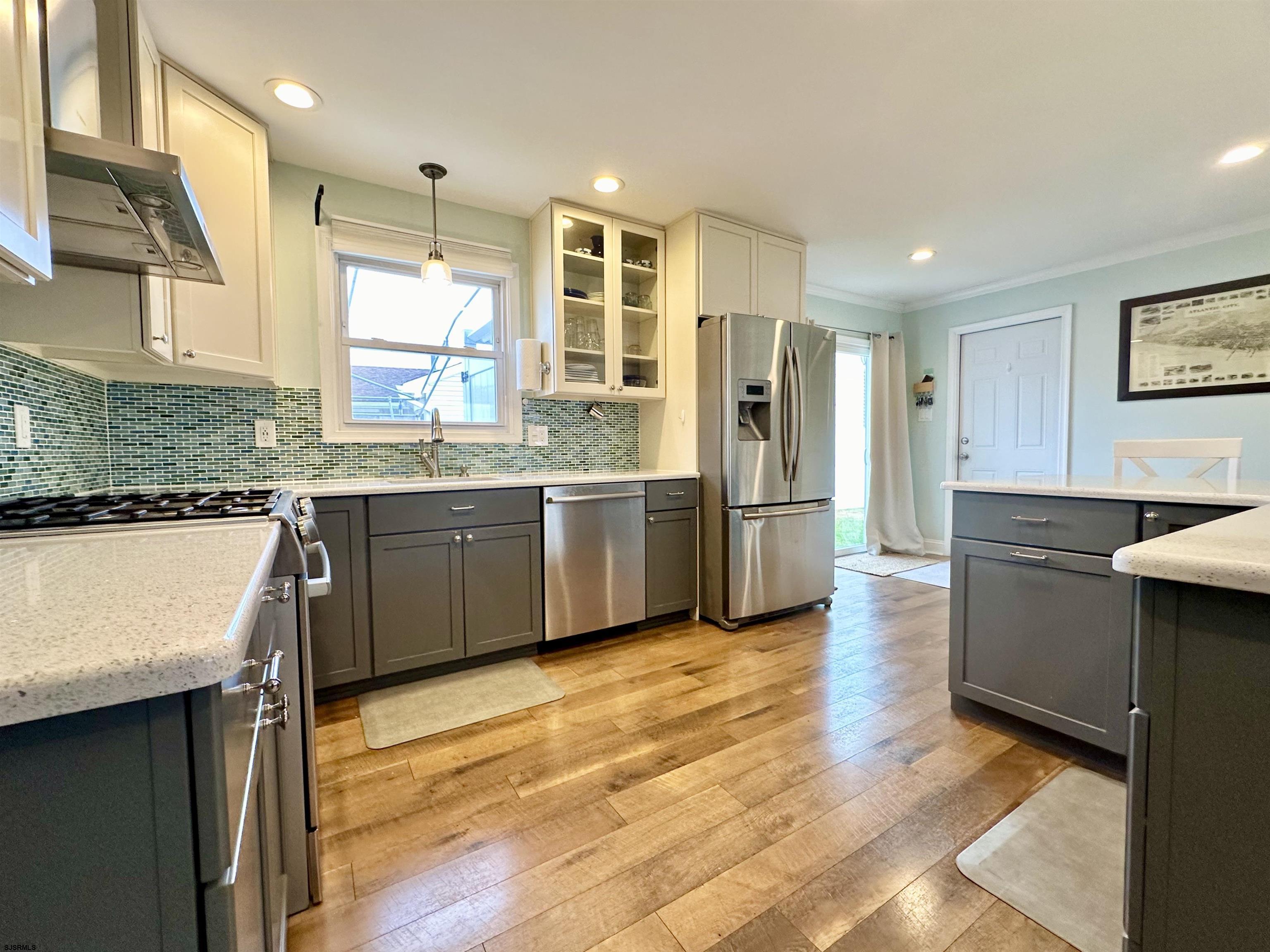 12 Explorer Road Brigantine, NJ 08203 - Photo 8 of 44 a kitchen with stainless steel appliances granite countertop a refrigerator a sink a stove and wooden floors