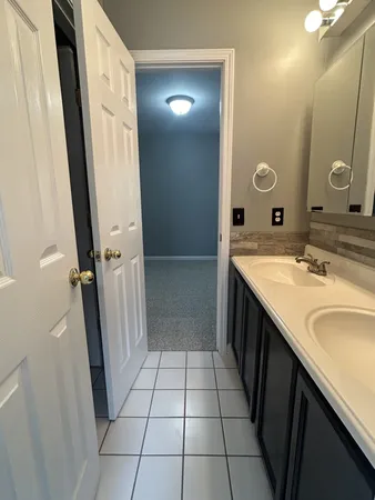 a bathroom with a double vanity sink and mirror