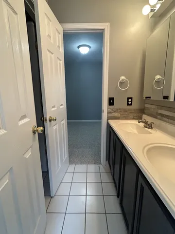 a bathroom with a double vanity sink and mirror