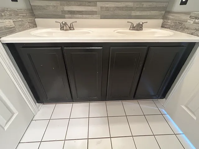 a bathroom with a sink a mirror and vanity