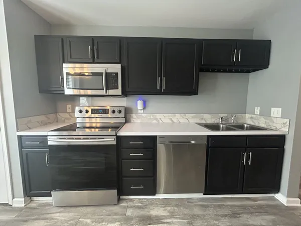 a kitchen with a sink and a stove top oven