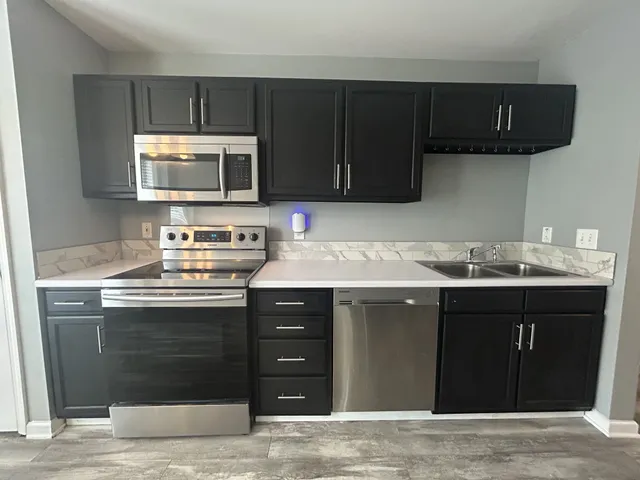 a kitchen with a sink and a stove top oven