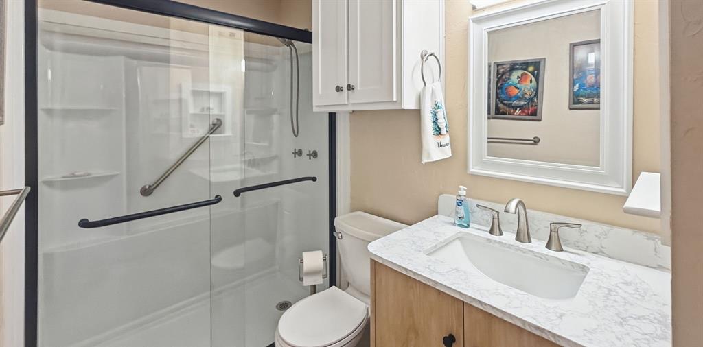 3037 Hells Gate Loop, Unit C208 Strawn, TX 76475 - Photo 20 of 24 a bathroom with a granite countertop sink toilet and shower