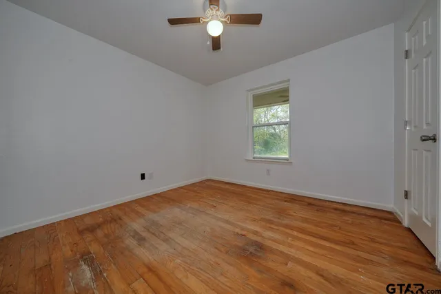 a view of a room with wooden floor and cabinet