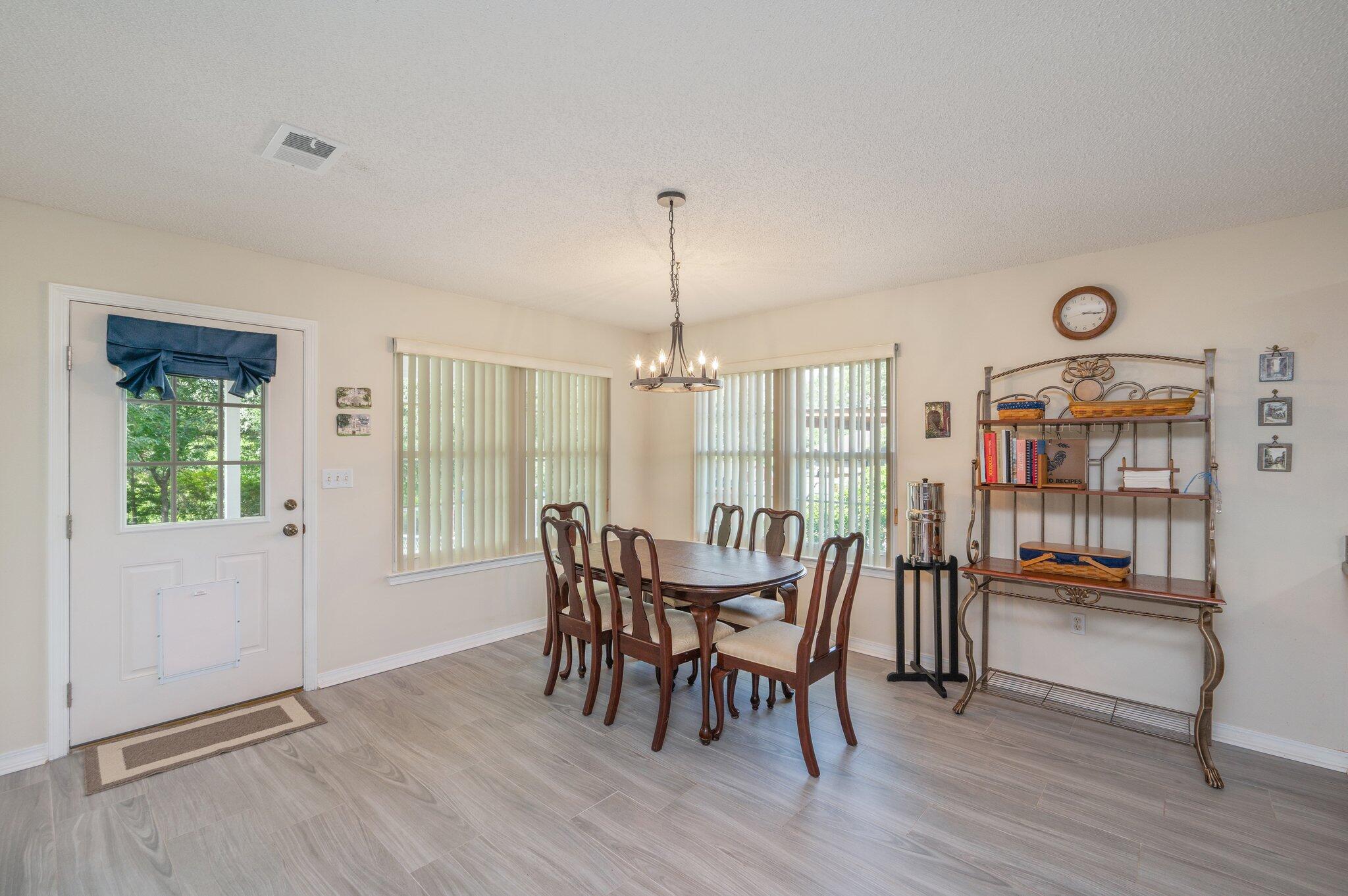 642 Alysheba Drive Crestview, FL 32539 - Photo 12 of 32 a dining room with furniture and wooden floor