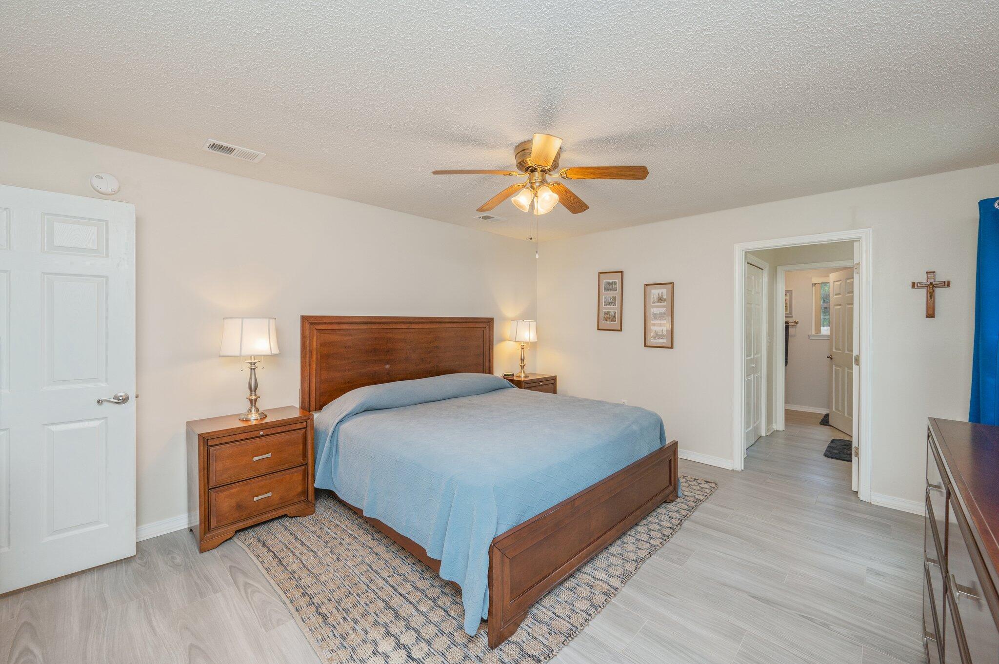 642 Alysheba Drive Crestview, FL 32539 - Photo 14 of 32 a bedroom with a bed and a chandelier