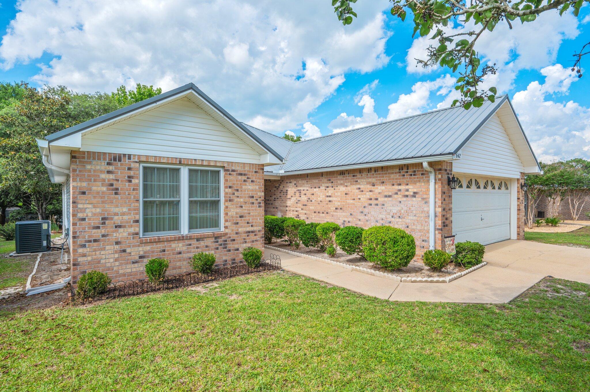 642 Alysheba Drive Crestview, FL 32539 - Photo 3 of 32 a front view of a house with garden