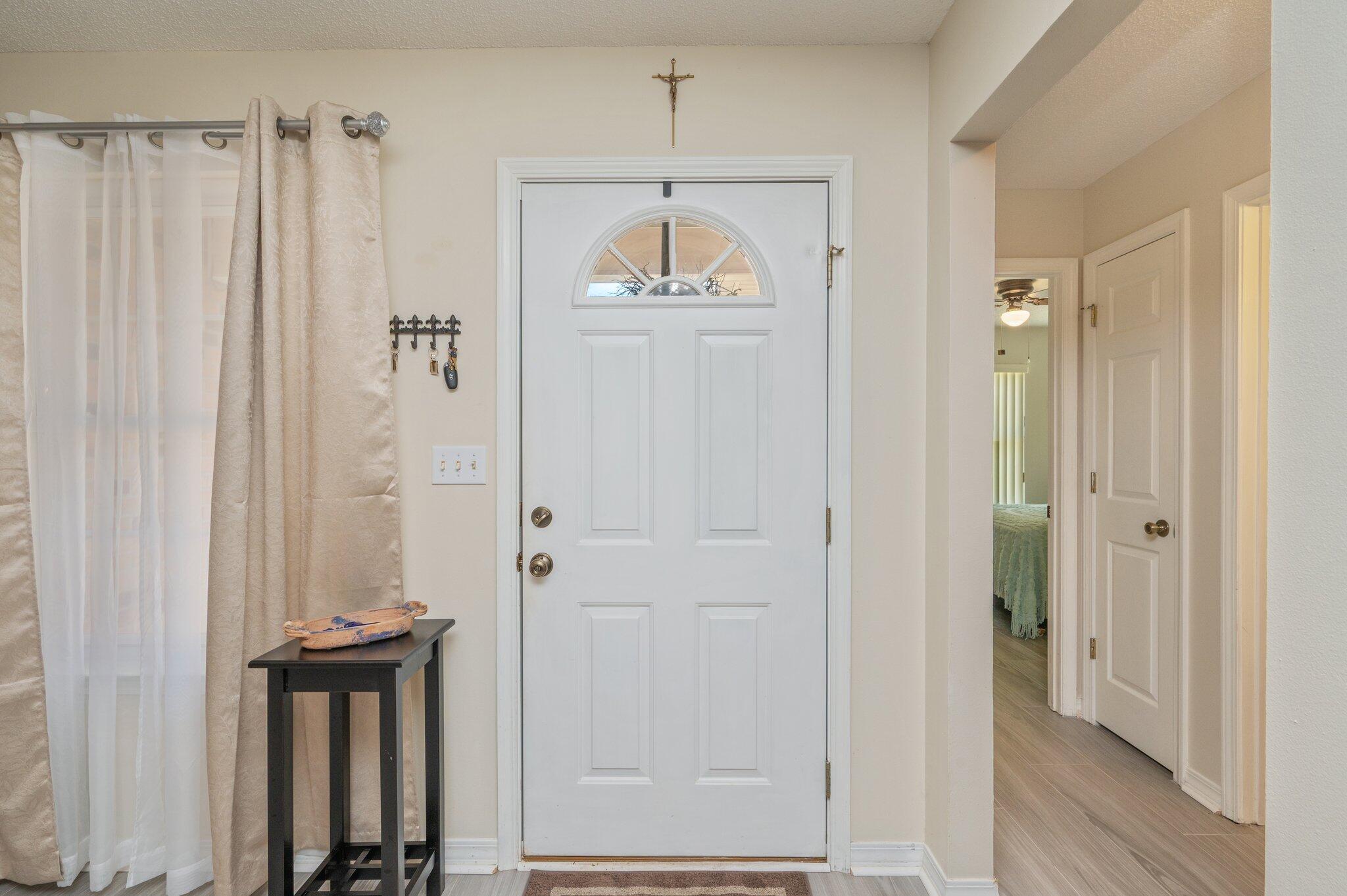642 Alysheba Drive Crestview, FL 32539 - Photo 5 of 32 a view of a hallway with entryway and wooden floor