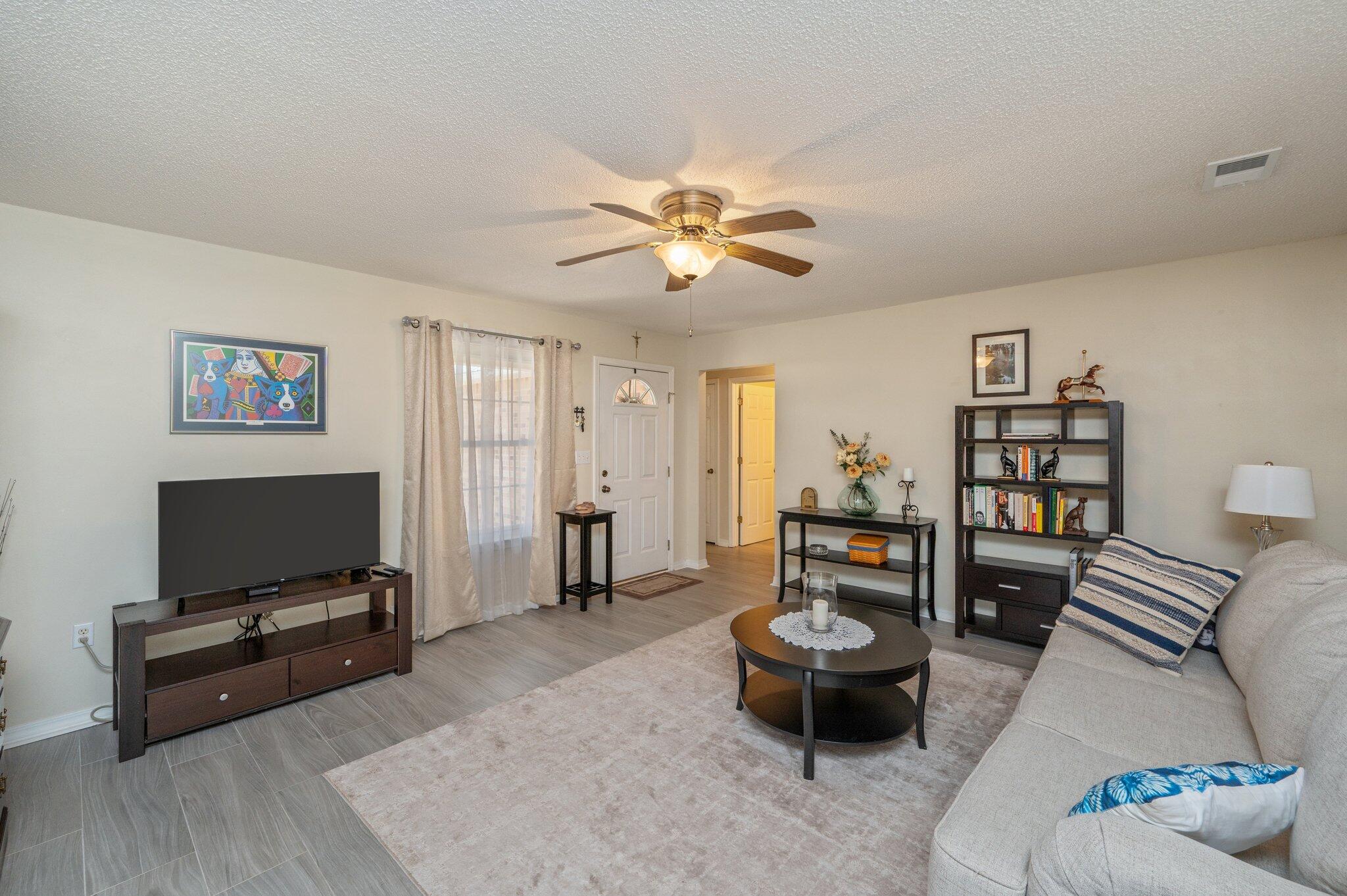 642 Alysheba Drive Crestview, FL 32539 - Photo 6 of 32 a living room with furniture and a flat screen tv