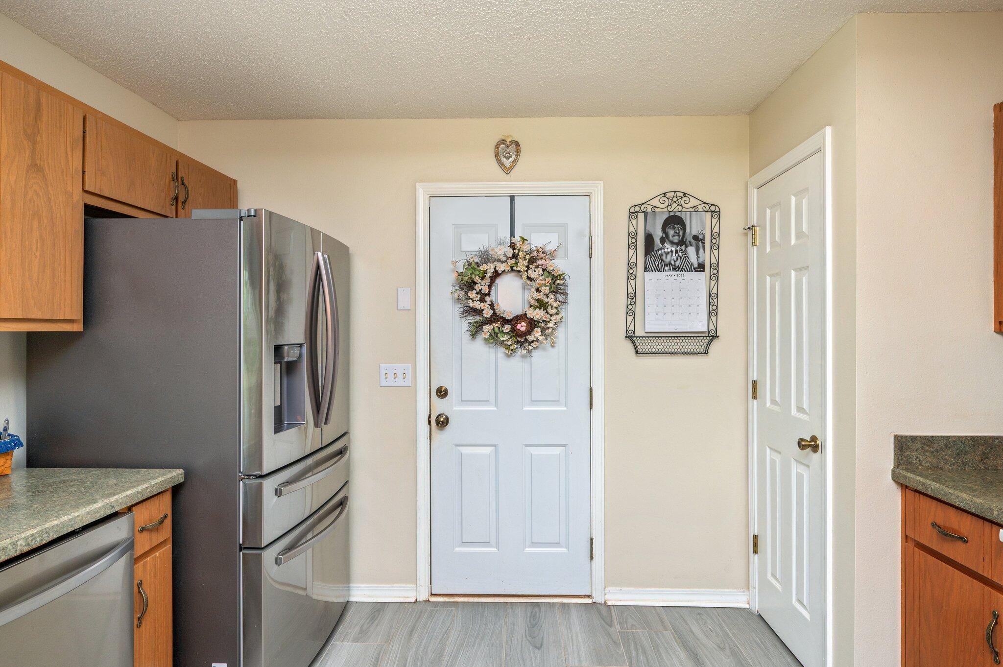 642 Alysheba Drive Crestview, FL 32539 - Photo 9 of 32 a kitchen with stainless steel appliances a refrigerator and cabinets