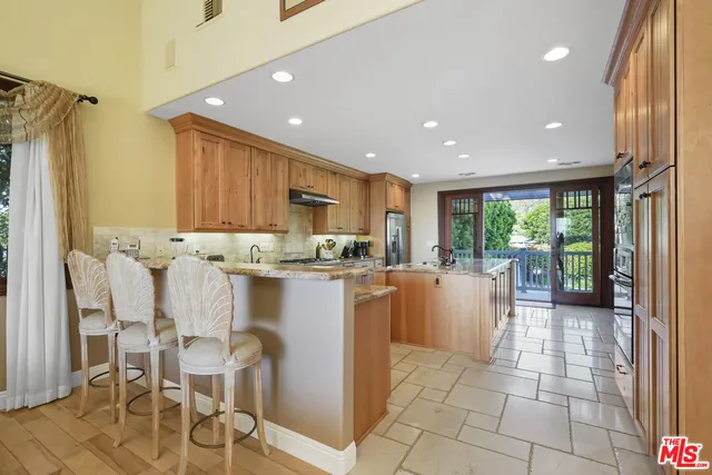 a kitchen with stainless steel appliances granite countertop a sink and cabinets