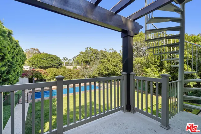 a view of a balcony with table and chairs