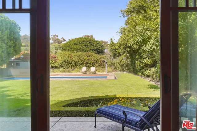 a utility room with stainless steel appliances wooden floor and large window