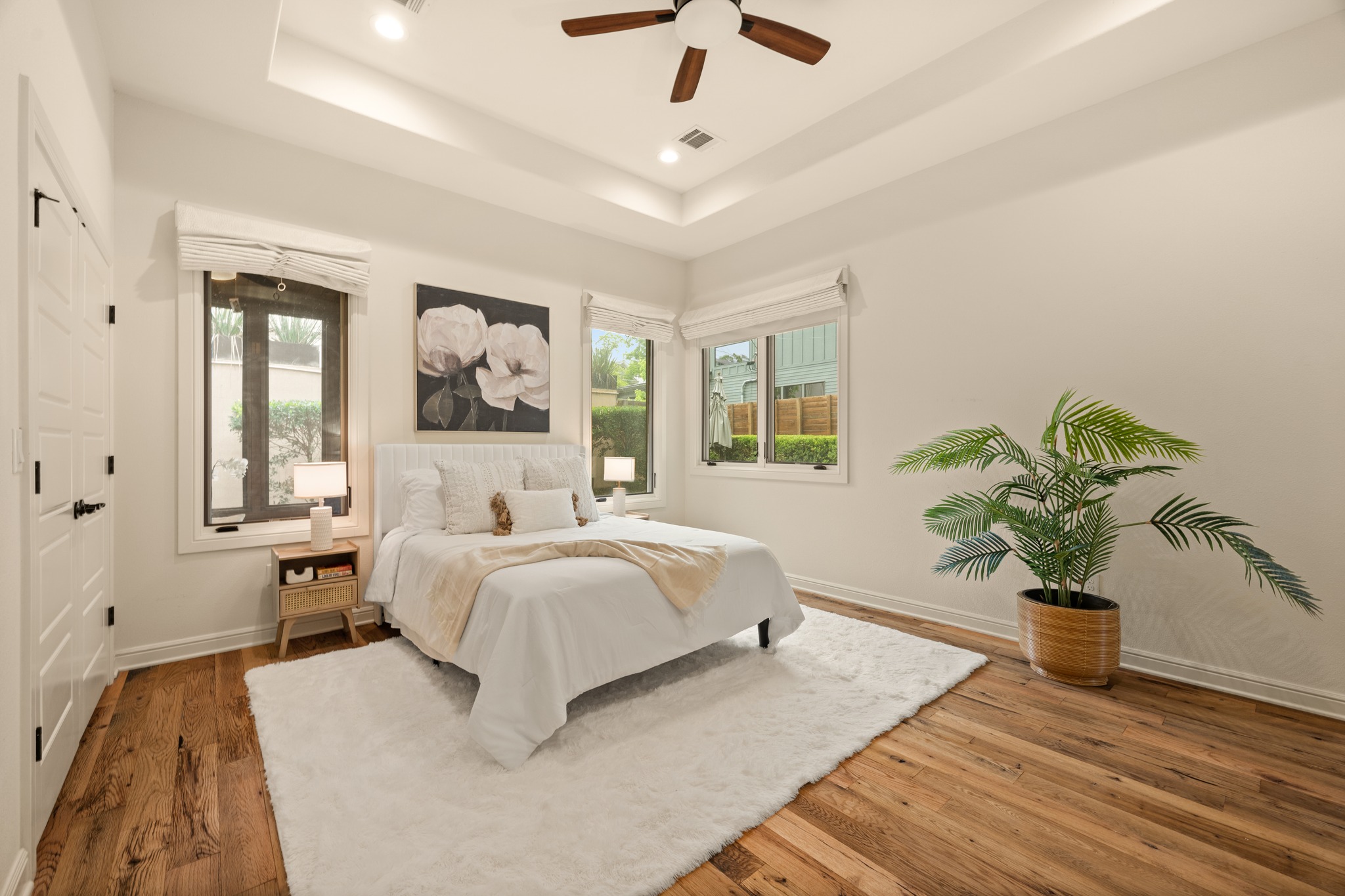 3907 Bailey Lane Austin, TX 78756 - Photo 15 of 40 It will be hard to find a better owner's suite than this one, with dreamy natural light, custom built-ins, a high tray ceiling, and breathtaking reclaimed wood flooring