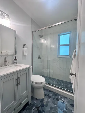 a bathroom with a sink toilet and shower